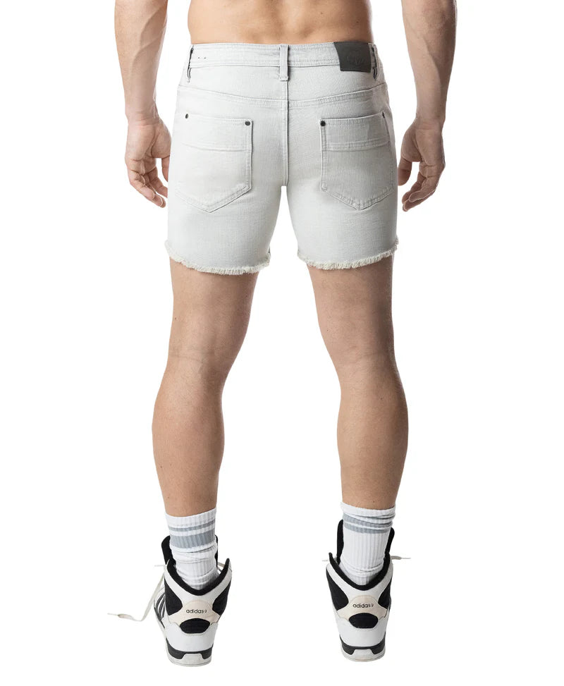Person wearing white denim shorts on a white background