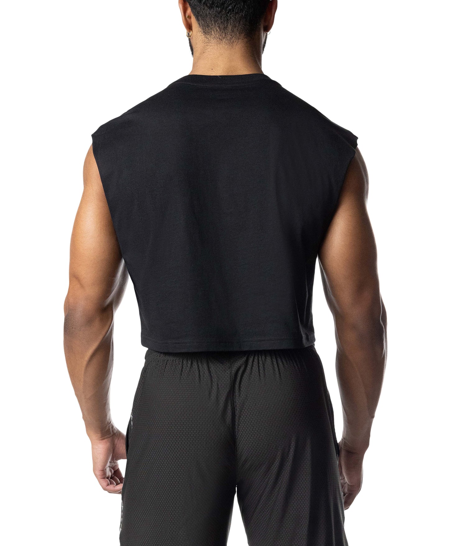 Person wearing a black sleeveless top and pants on a white background