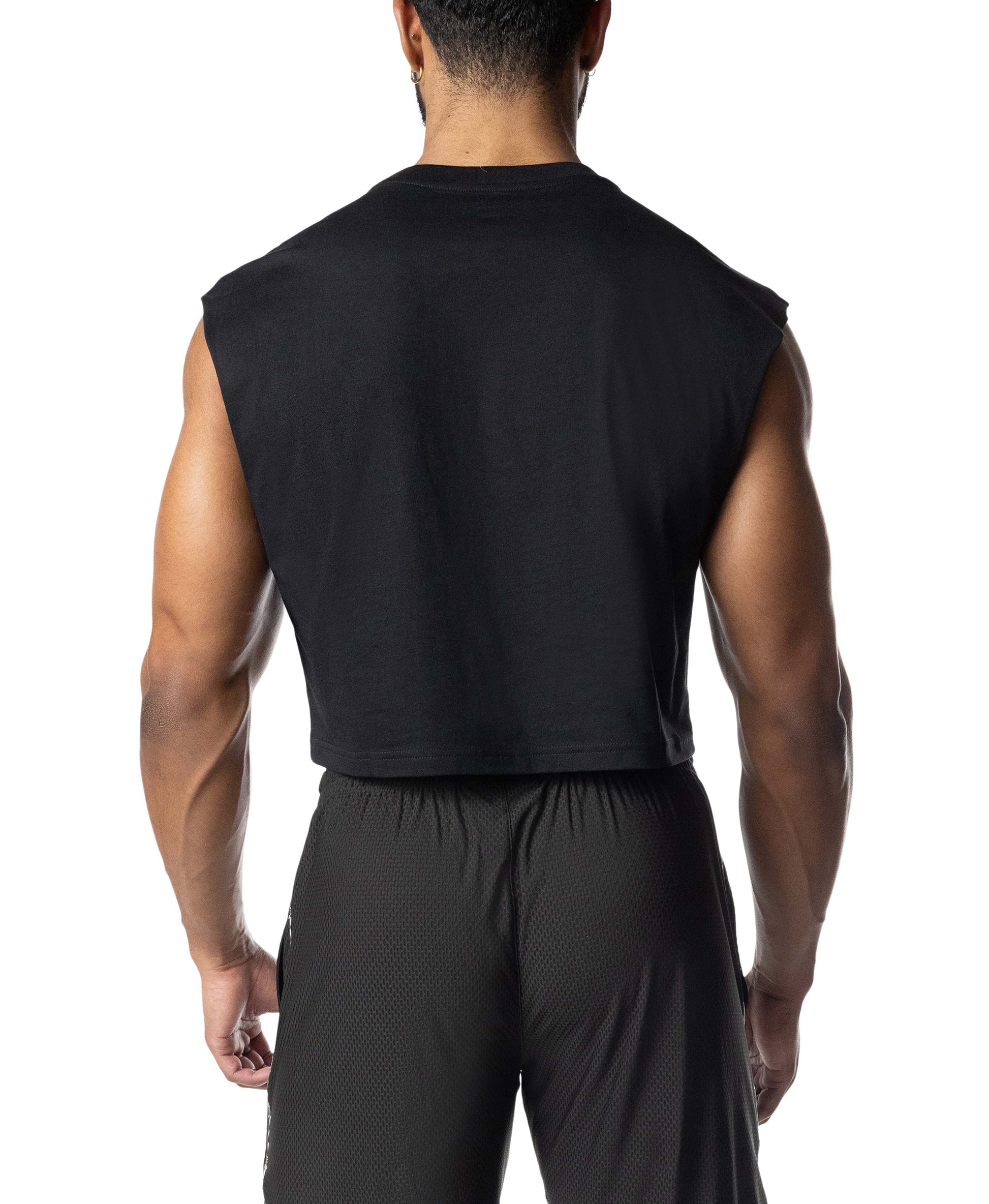 Person wearing a black sleeveless top and pants on a white background