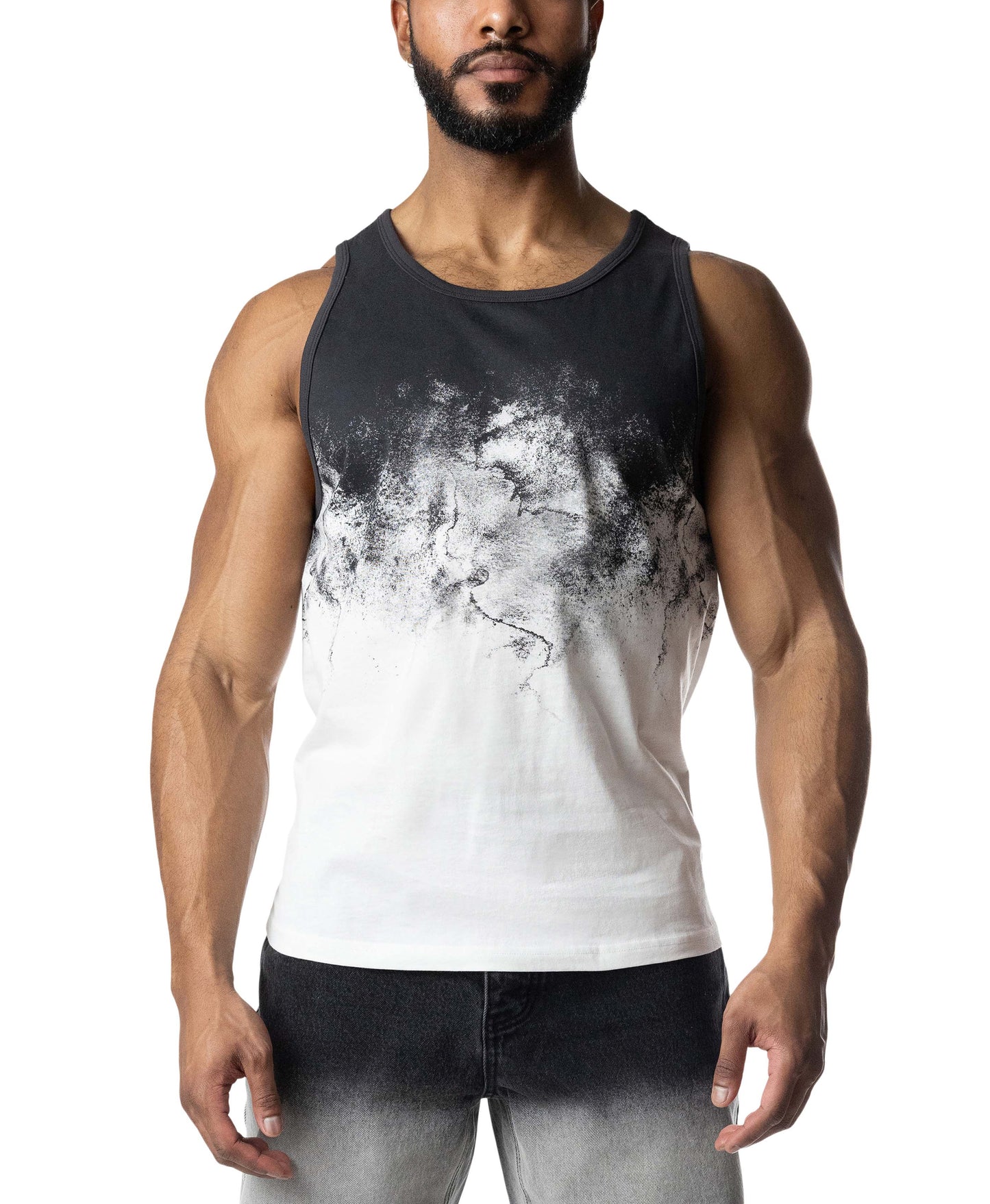 Man wearing a black and white tank top with abstract design on a white background