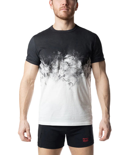 Man wearing a black and white graphic t-shirt with black shorts on a white background