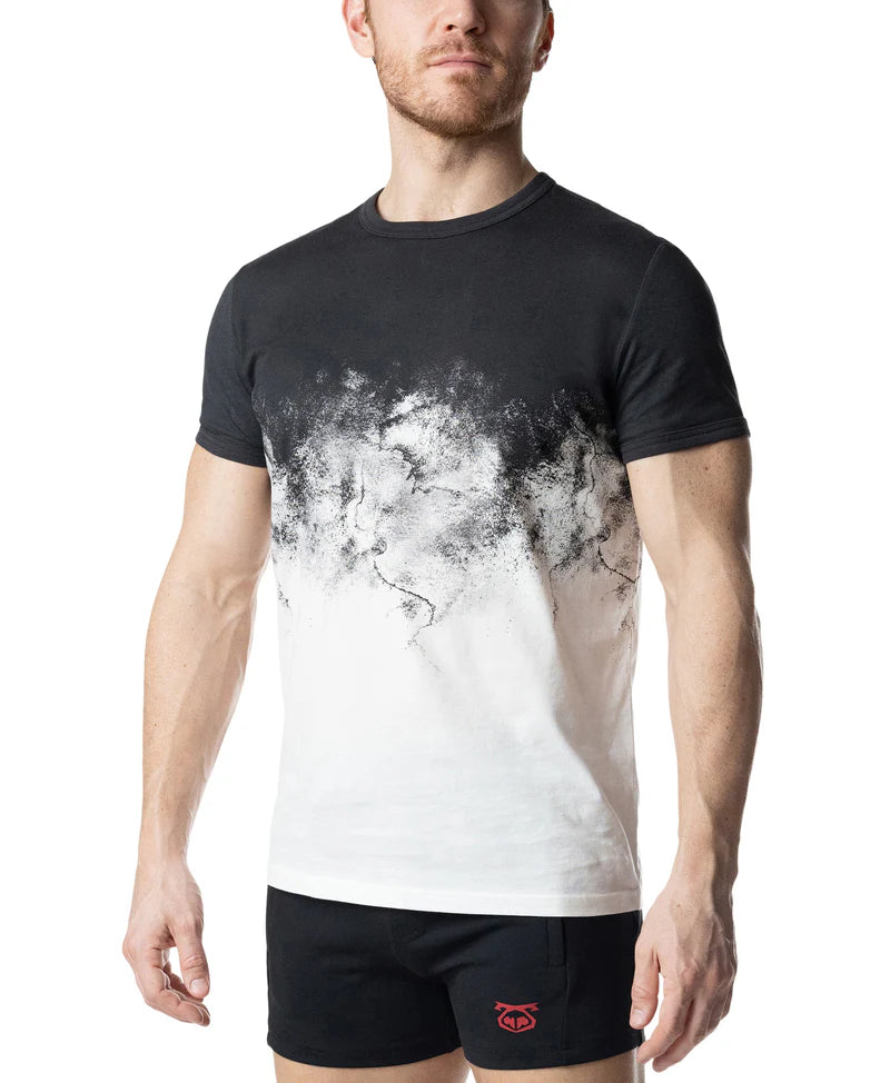 Man wearing a black and white graphic t-shirt with black shorts on a white background